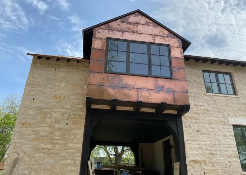 Copper metal panel facade on a stone building for Skylight Installation in Lafayette